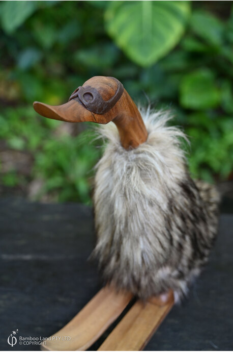 Duck on skis with fur coat